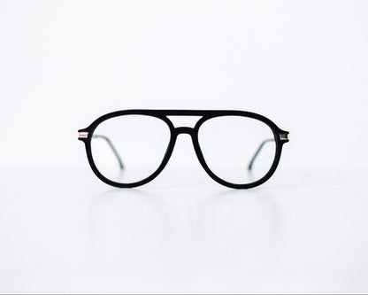 Front view of black velvet aviator glasses with matte black temples, displayed on a white background. The soft velvet texture gives a luxurious finish, available as reading glasses or blue light blocking glasses.