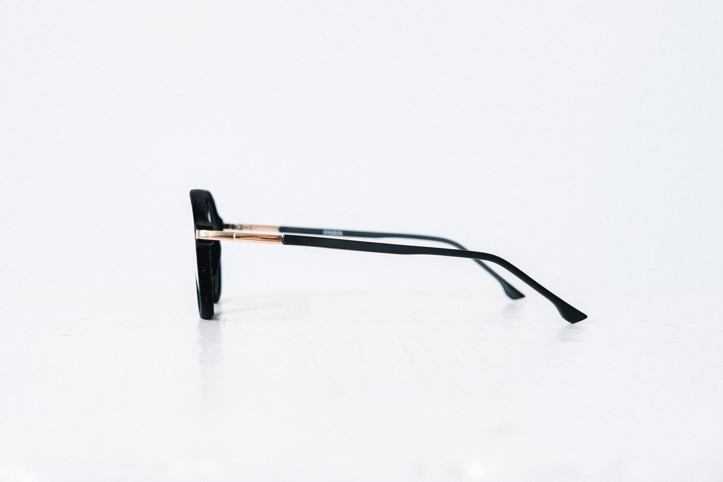 Side view of black velvet aviator glasses with matte black temples, displayed on a white background. The soft velvet texture gives a luxurious finish, available as reading glasses or blue light blocking glasses.