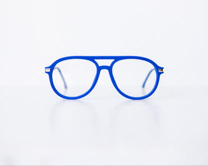 Front view of blue velvet aviator glasses with matte blue temples, displayed on a white background. These frames feature a soft velvet finish and are available as reading glasses or blue light blocking glasses.