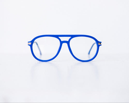 Front view of blue velvet aviator glasses with matte blue temples, displayed on a white background. These frames feature a soft velvet finish and are available as reading glasses or blue light blocking glasses.