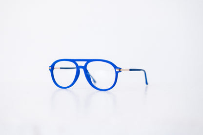 Side view of blue velvet aviator glasses with matte blue temples, displayed on a white background. These frames feature a soft velvet finish and are available as reading glasses or blue light blocking glasses.