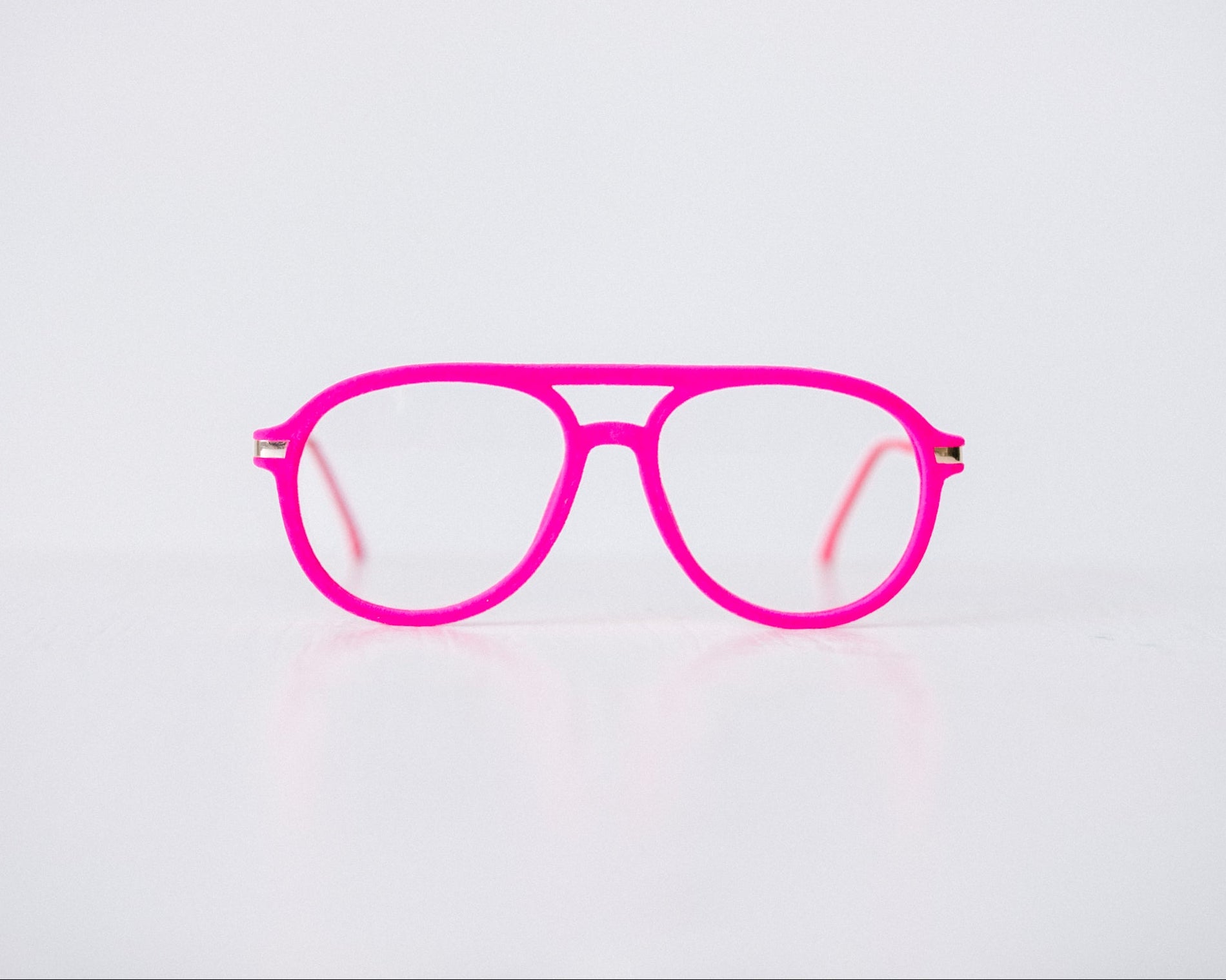 Front view of pink velvet aviator reading glasses displayed on a white background, showing the soft velvet texture and sleek, modern silhouette.
