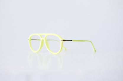 Side view of neon green and neon yellow velvet aviator glasses with matte temples, displayed on a white background. The bold, vibrant frame features a soft velvet texture and is available as reading glasses or blue light blocking glasses.