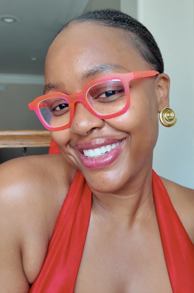 influencer wearing the Ibiza neon pink square designer reading glasses with blue light blocking lenses for computer screen time